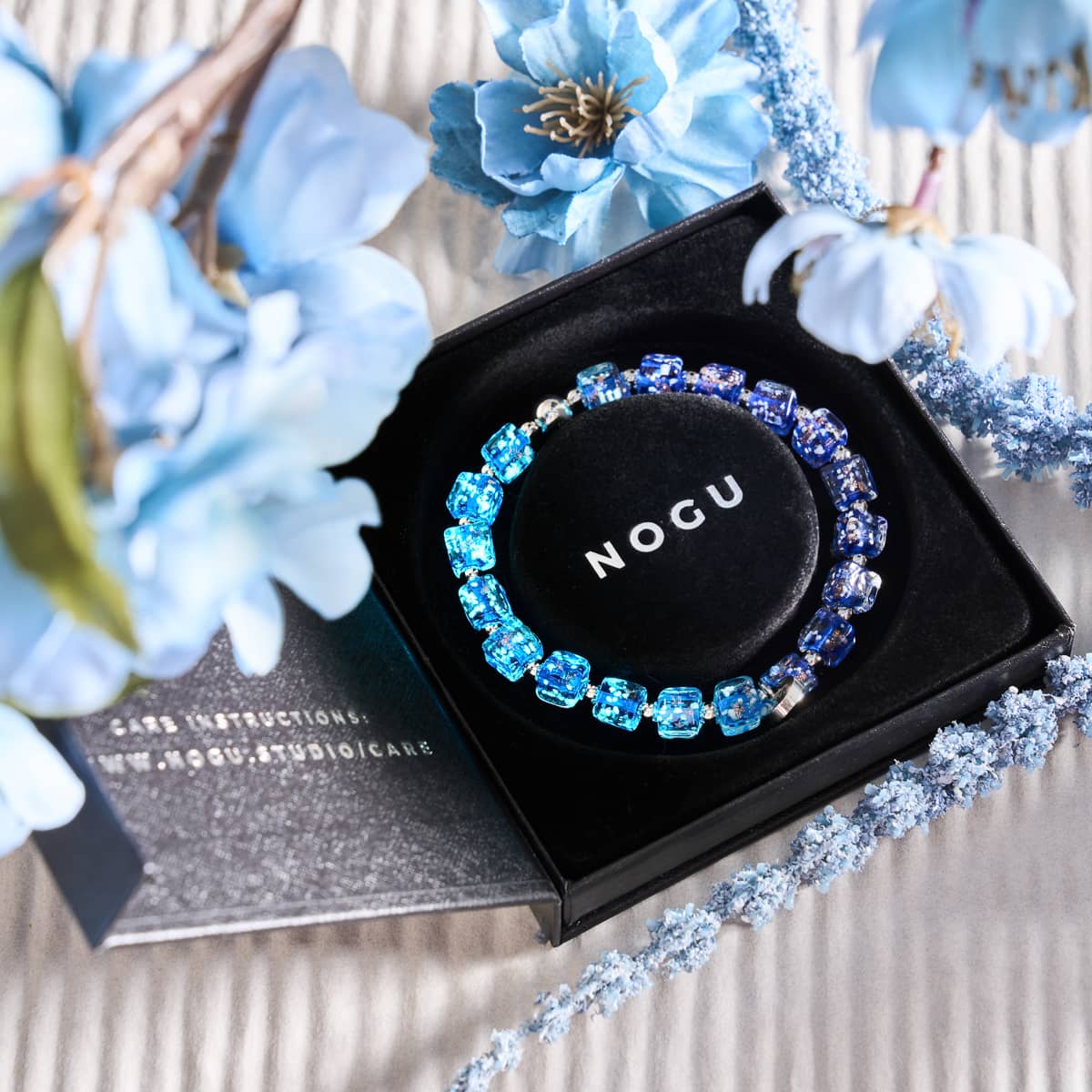 Sapphire Firefly Glass Pebble Bracelet with hand-blown blue glass beads in black gift box by NOGU